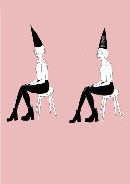 A hand drawn image of a young woman with a black cap that says "dunce," sitting on a stool. The figure is repeated twice, with her face tilted in a different direction both times. The background is empty and a medium-toned pink.
